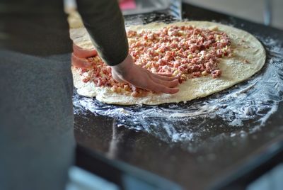 Midsection of person preparing food in kitchen