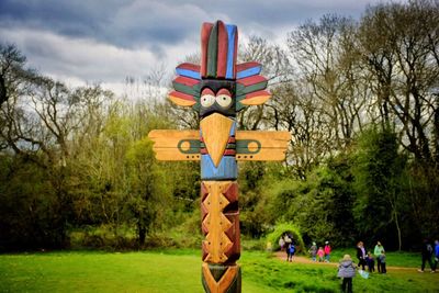 Traditional windmill on field against sky