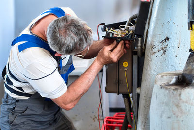 Side view of man working at construction site