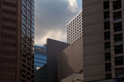 Low angle view of modern buildings in city against sky