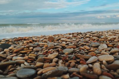 Pebbles on beach against sky