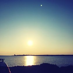 Scenic view of sea against clear sky during sunset