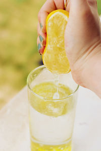 Close-up of hand squeezing lemon
