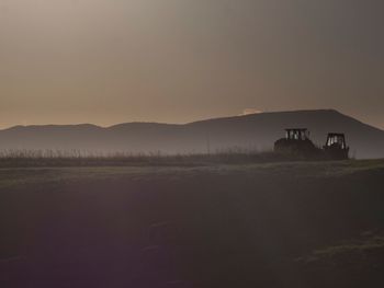 Scenic view of field against sky during sunset