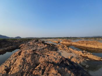 Scenic view of rocks against clear sky