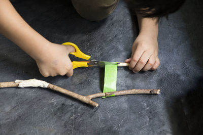 High angle view of person working with sticks on floor