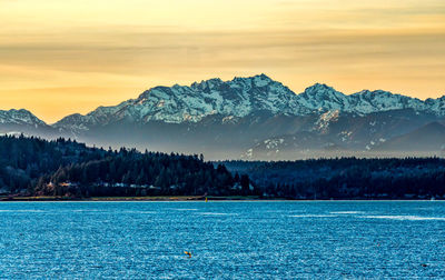 A sunset with the olympic mountains across the puget sound.