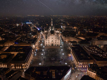 Aerial view of piazza duomo in front of the gothic cathedral in the center of milan at night.