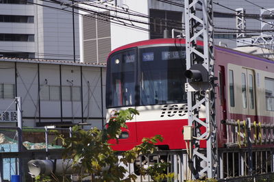 Low angle view of train against buildings in city