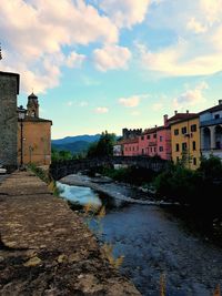 River amidst buildings against sky in city