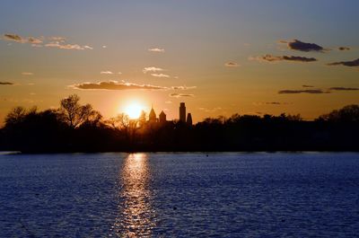 Scenic view of river at sunset