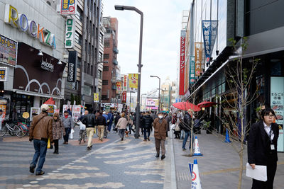 People walking on street amidst buildings