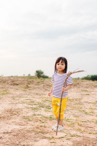 Portrait of girl standing on field