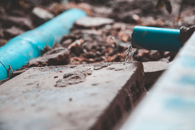 Close-up of messy pipe with text on metal