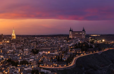 High angle view of city lit up at night