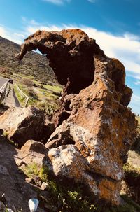 Rock formation on land against sky