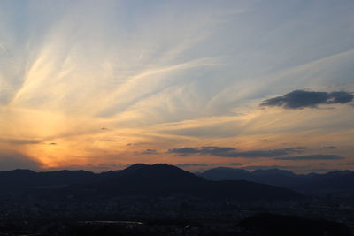 Scenic view of silhouette mountains against sky during sunset