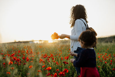 Mother aand daughter on poppy field