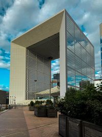 Modern building against cloudy sky