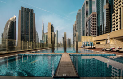 View of swimming pool against buildings in city