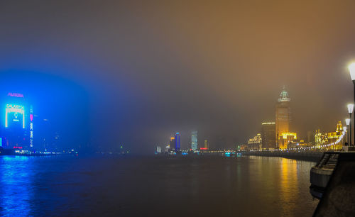 Illuminated city at waterfront