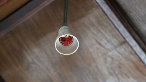 Low angle view of bulb holder hanging on ceiling