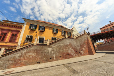 Low angle view of buildings in city against sky