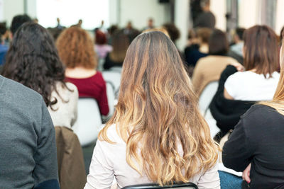 Rear view of business people attending seminar