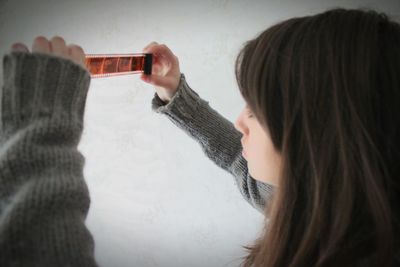 Young woman looking at photo negative