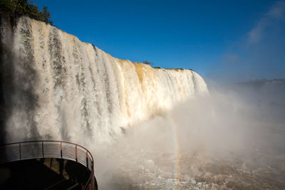 Panoramic view of waterfall against sky