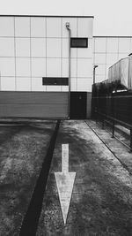 Empty road along buildings