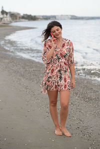 Young woman standing at beach