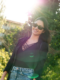 Young woman wearing sunglasses standing outdoors