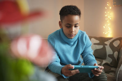 Boy playing video games at home