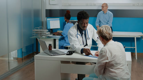 Doctor getting document signed by patient