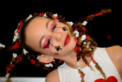 Close-up of young woman with flowers