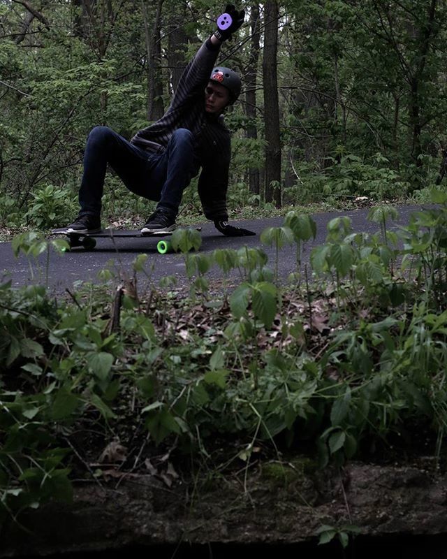 YOUNG WOMAN JUMPING IN FOREST