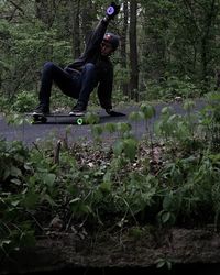 Woman jumping in forest