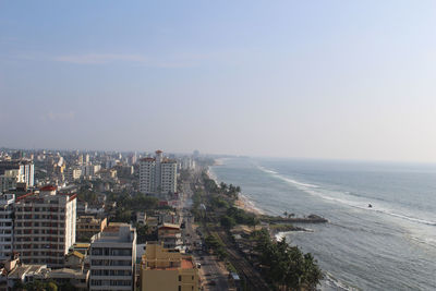 High angle view of cityscape by sea against sky