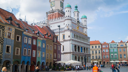 People on street against buildings in town