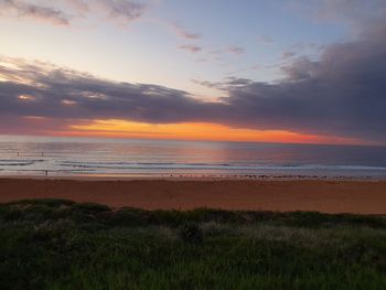 Scenic view of beach against sky during sunset