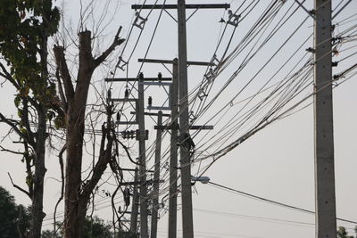 Low angle view of electricity pylon against sky