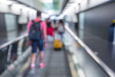 Low section of people walking on railroad station platform