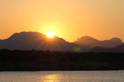 Scenic view of silhouette mountains against sky during sunset