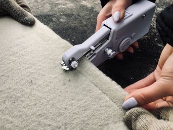 Cropped image of woman sewing carpet