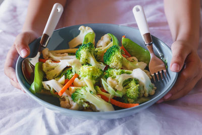 Midsection of woman holding food on table