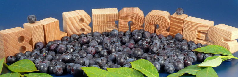 High angle view of blueberries and text against blue background