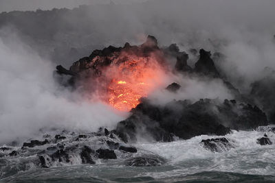 Red-hot lava enters the ocean on the big island of hawaii during a recent volcanic eruption