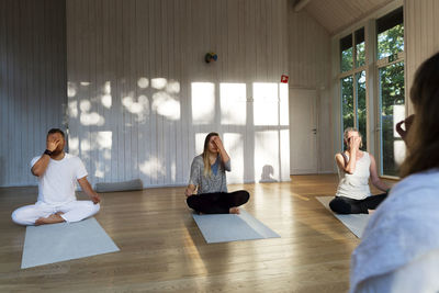 People practicing yoga in class