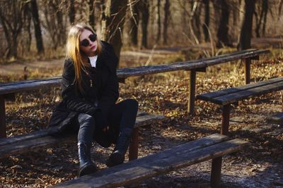 Beautiful woman sitting on bench in park